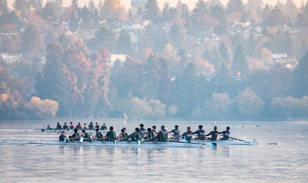 Three eight-person rowing shells on Green Lake at the 2019 Frostbite Regatta.